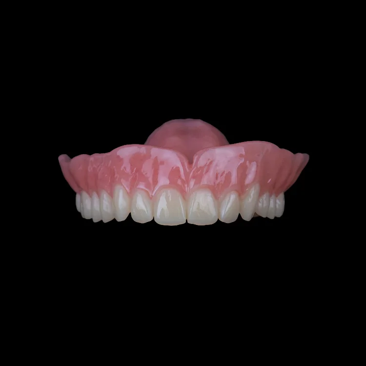 A complete upper denture on a black ground