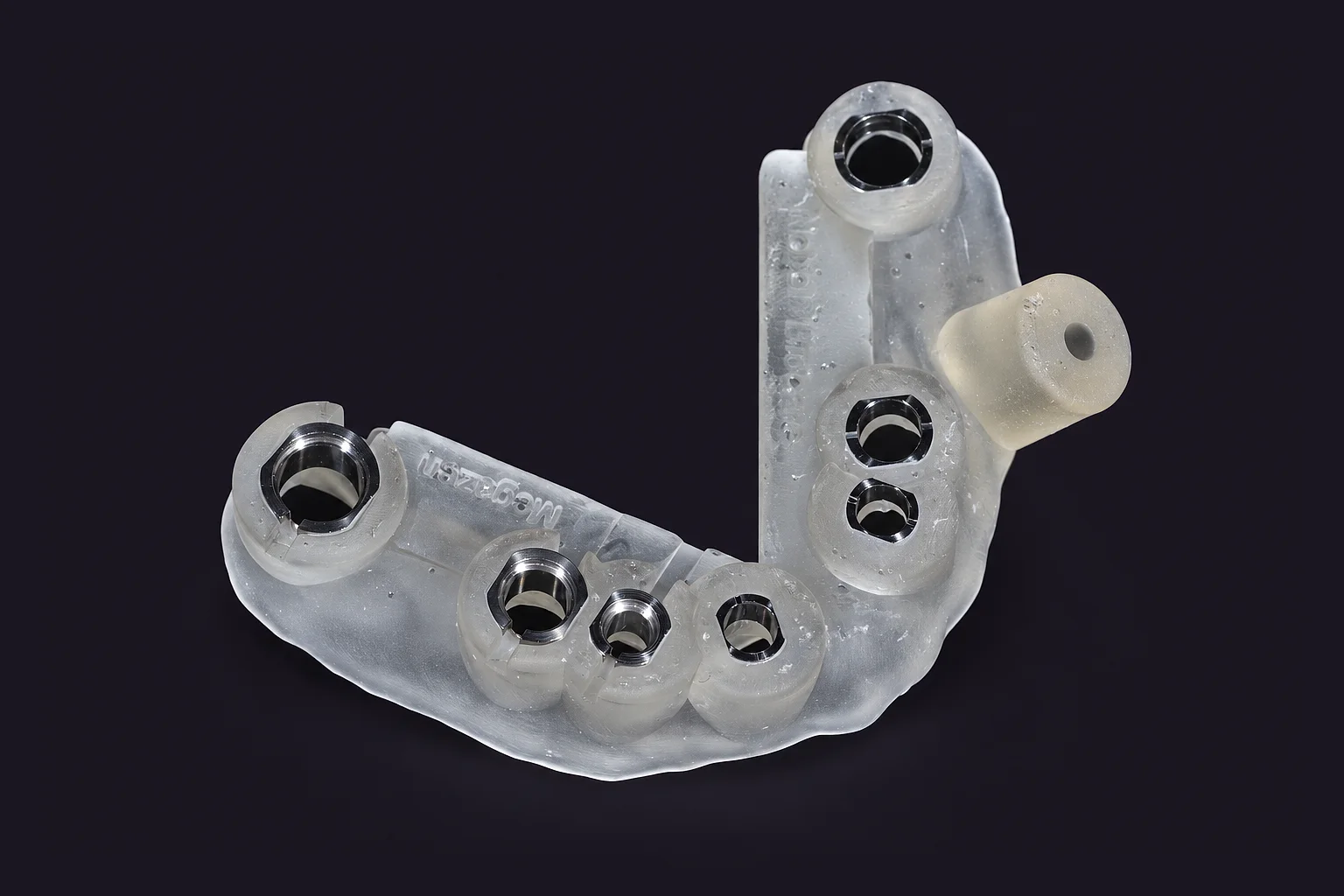 A clear printed linkGuide for a full arch, metal sleeves set in the resin