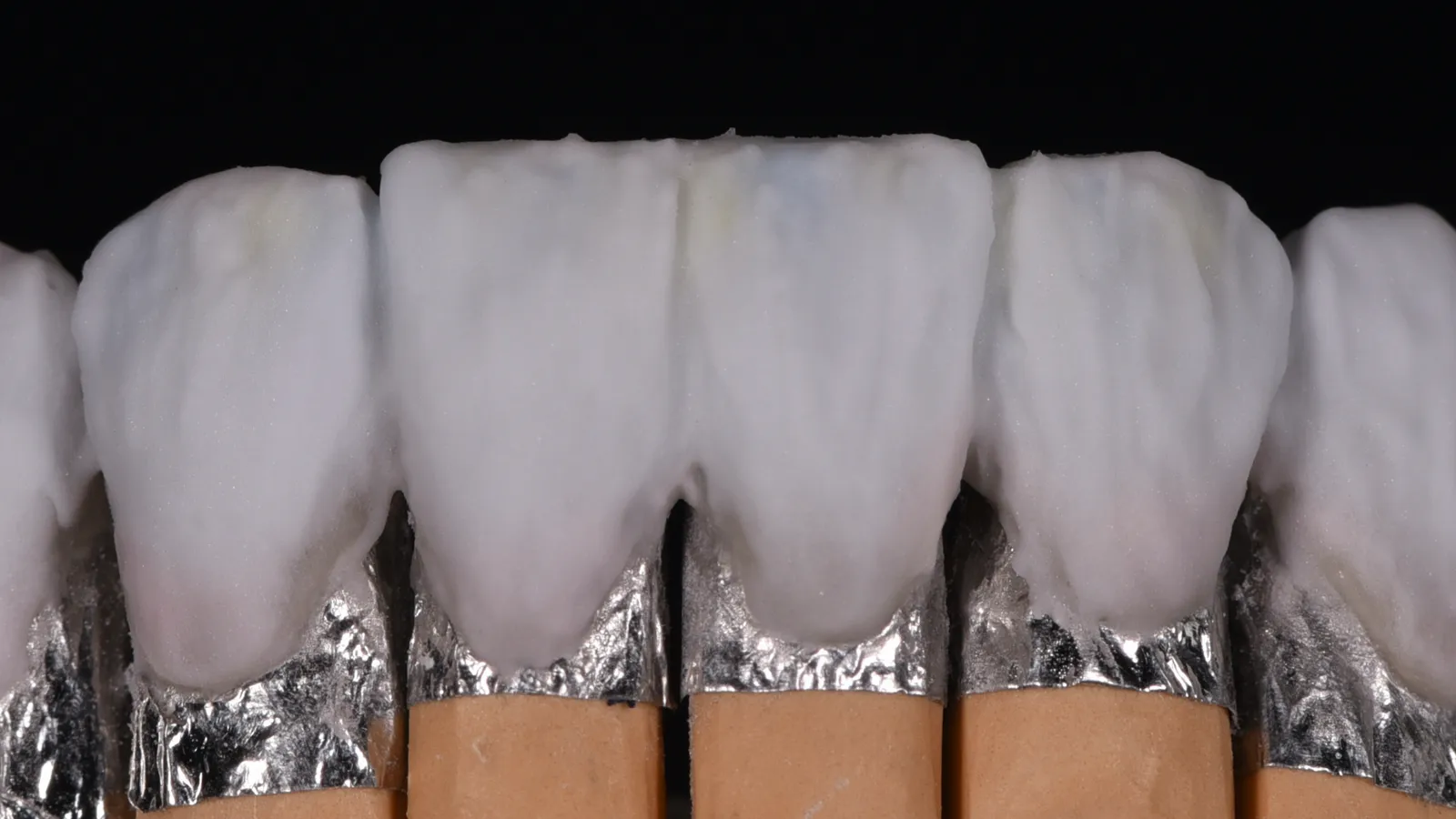 Dies wrapped in platinum foil, feldspathic porcelain built up on each, before firing