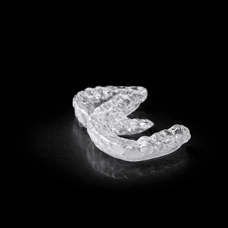 A clear retainer on a black ground