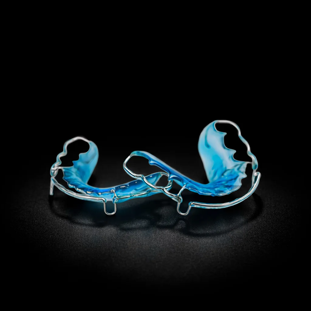 A Hawley retainer with a blue acrylic plate and a labial bow
