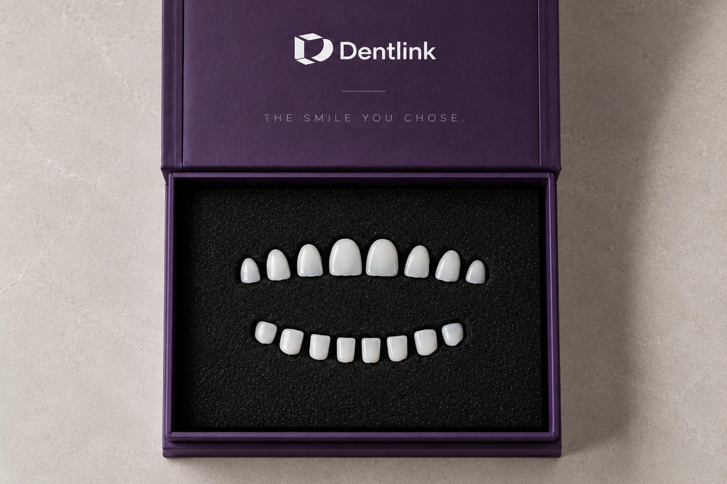 An open Dentlink box, the finished veneers set in it