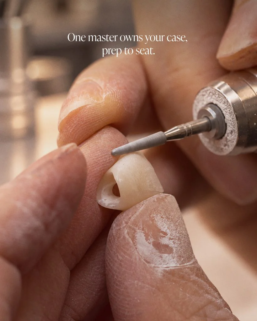 Master ceramist checking a crown at a dental lab