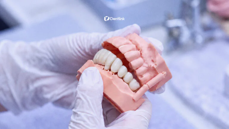 Master dental technician refining a restoration to help reduce dental crown remakes